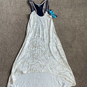 Ring spun light weight dress. Shorter in front. Beading detail in back